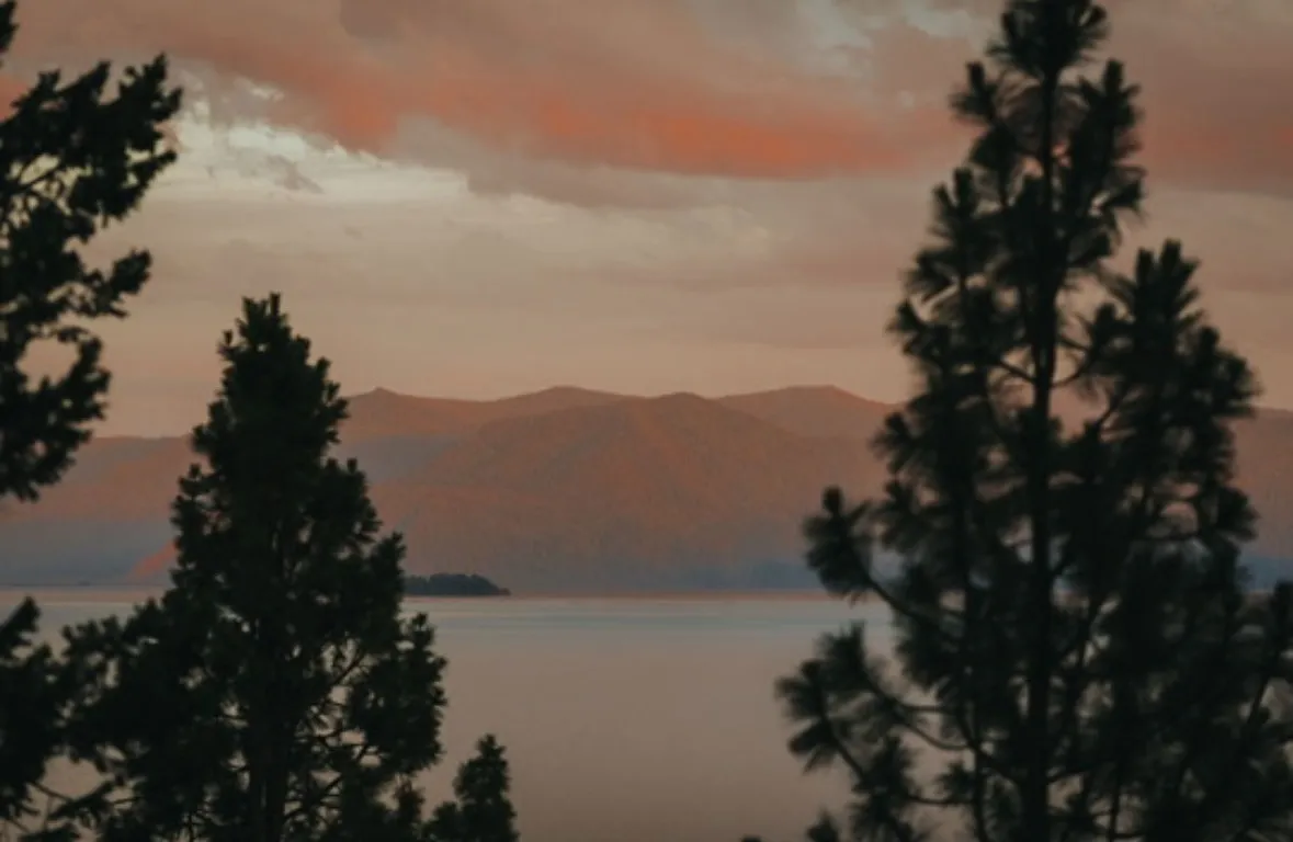 Sunset over mountains and water, representing a peaceful dream birth visualization.